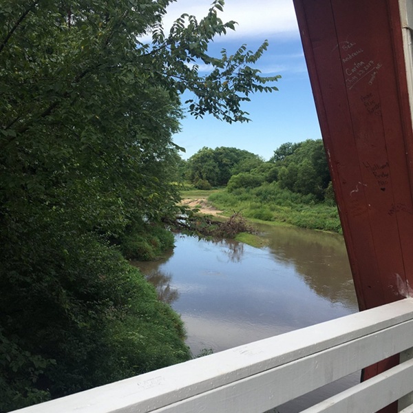 Visitors can enjoy a peaceful setting at the bridge, with nearby picnic spots and scenic views of the Iowa countryside. 