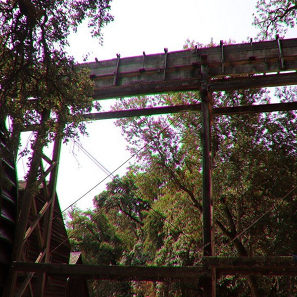The four-story wooden mill is powered by a 36-foot wooden water wheel, which turns massive millstones used to grind grain—visitors can often watch the historic machinery in operation during demonstrations. 