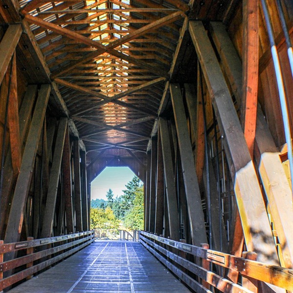 The bridge is a Howe truss design, a type of wooden bridge engineering widely used during the late nineteenth and early twentieth centuries because it could support extremely heavy railroad loads. 