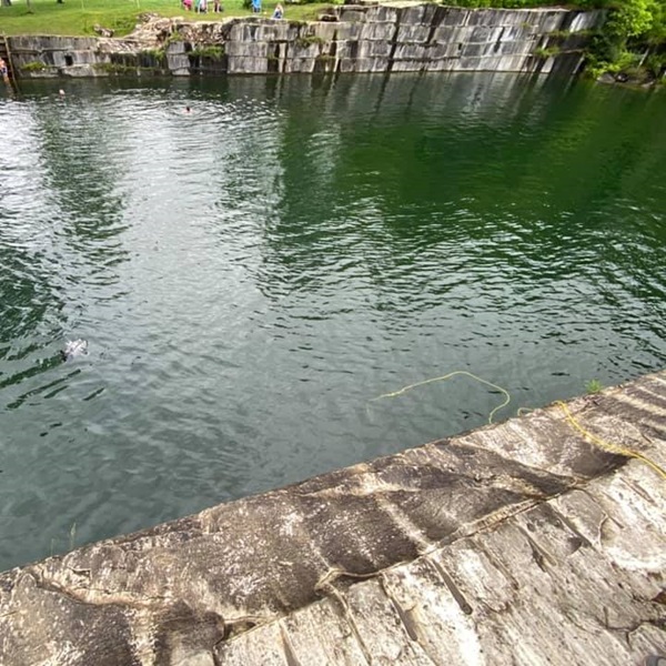 The quarry is filled with clear, cool water, surrounded by steep marble walls, making it a unique and scenic place for swimming and picnicking. 