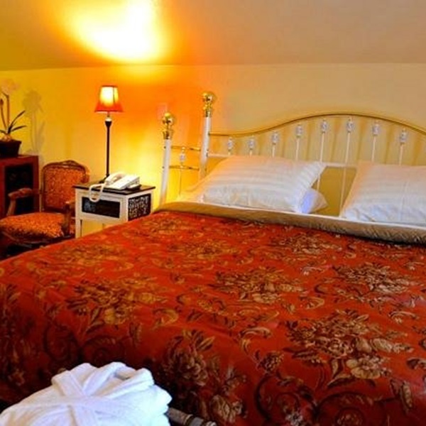 The Country Inn offers a range of rooms and suites, each uniquely decorated to provide a cozy and comfortable stay. 