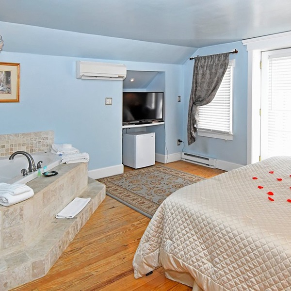 Some rooms feature whirlpool tubs, balconies, and views of the surrounding area. 
