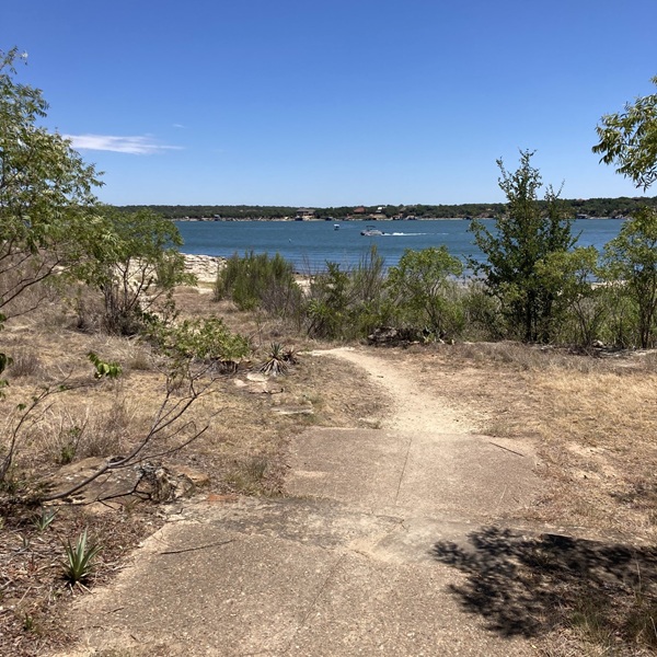 The Nopales Ridge Trail is part of the Lake Brownwood State Park trail system, offering a natural cycling route through rugged Texas Hill Country terrain. 