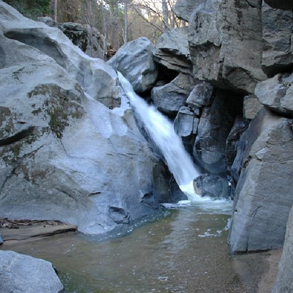 Seeley Creek plunges about 20 feet next to a natural heart-shaped hole, created by erosion, for which the falls is named. 