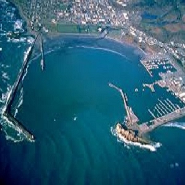 Aerial view of the Crescent City Harbor with Battery Point Lighthouse in the top left corner.