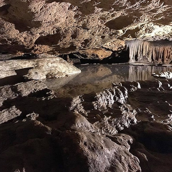 During the last million years, acidic groundwater dissolved crevices just below the surface creating cave passages. 