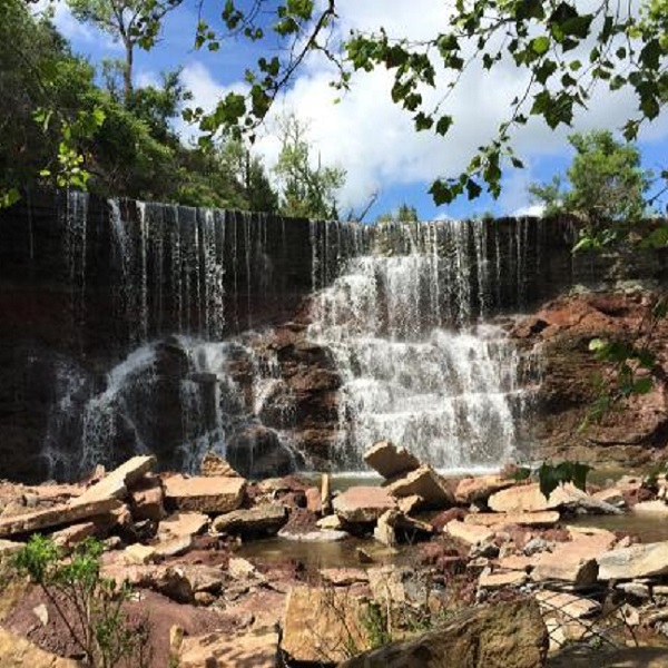 Many flat rocks at the base of the falls allows for a comfortable viewing spot. 