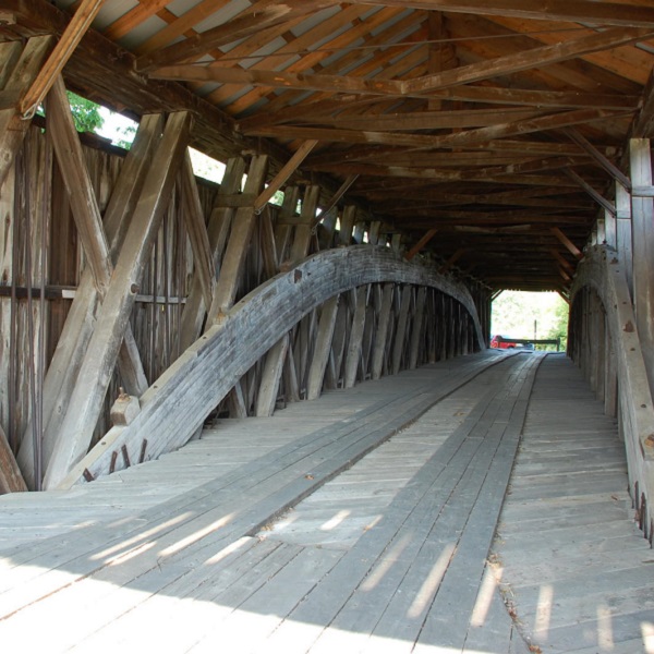The bridge is a Howe truss design with arches. 
