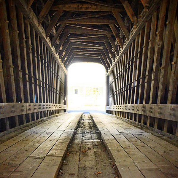 The Hall Covered Bridge is a classic example of a Paddleford truss bridge, named after its designer, Peter Paddleford. 