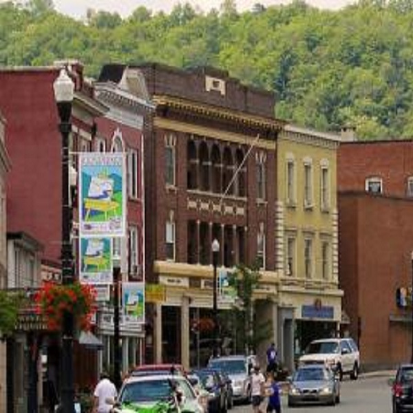 Signs mark the entry ways to the RiverWalk, a brick path along the Saranac River that winds its way through downtown.
