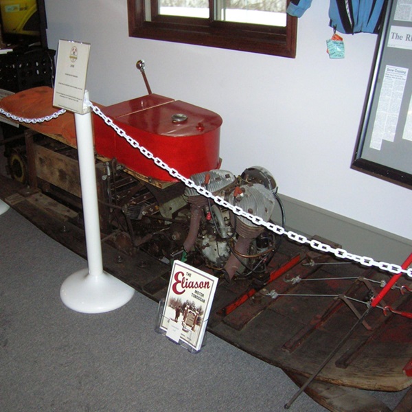 Journey through time with a collection of vintage snowmobiles spanning decades. 