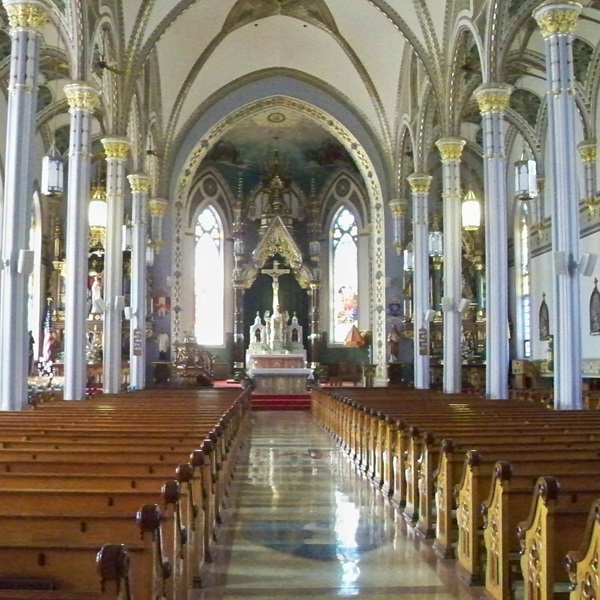 The basilica is a magnificent Romanesque-style church known for its intricate stained glass windows, towering spires, and ornate architecture. 