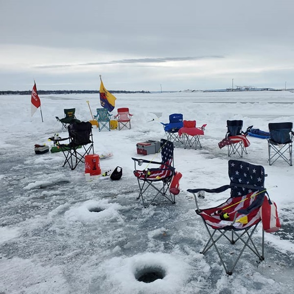 Families often participate together, creating lasting memories and enjoying quality time outdoors on the frozen lake. 