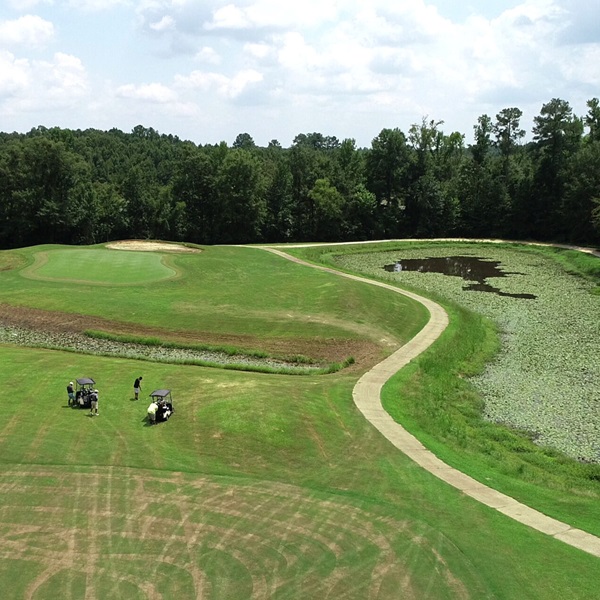 Its terrain includes elevated tees and rolling fairways framed by heavily wooded landscapes, providing a serene and beautiful golfing experience. ​ 