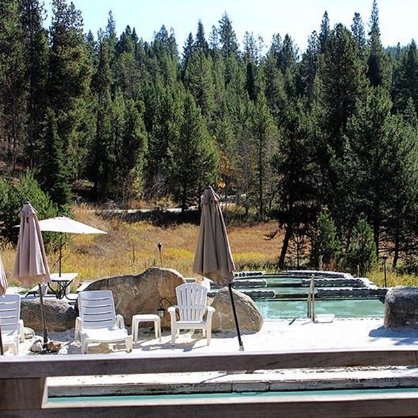 The hot springs are nestled in the foothills of the North Fork Range and surrounded by towering Ponderosa Pines. 