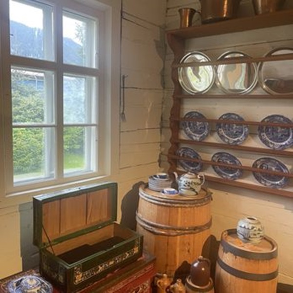 The building is an excellent example of Russian colonial architecture, featuring traditional log construction with detailed woodwork and a distinctive steep roof. It has been meticulously restored to reflect its original appearance. 