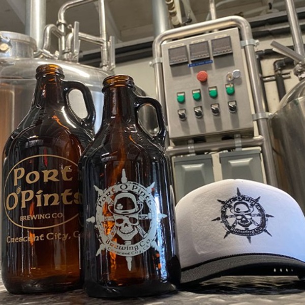 A selection of brewery merchandise, including branded apparel, glassware, and other items, is available for purchase. 