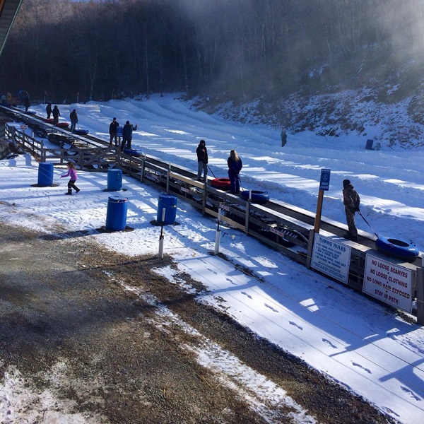 The park features a magic carpet lift, which is a conveyor belt that carries tubers back to the top of the hill after each run. 