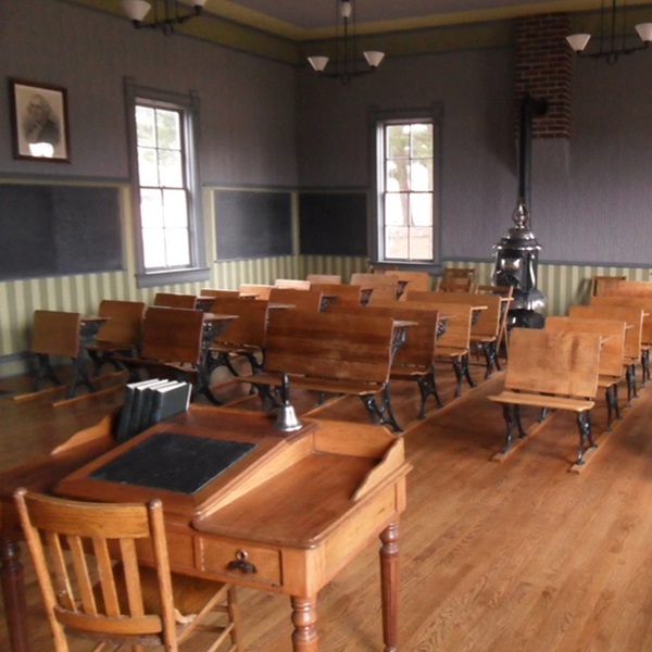 Visitors can explore a meticulously preserved classroom environment, complete with vintage desks, chalkboards, and educational materials from the era. 