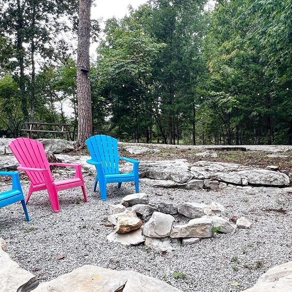Each glamping site includes a private outdoor area with amenities such as fire pits, picnic tables, and seating, perfect for enjoying the natural surroundings.  