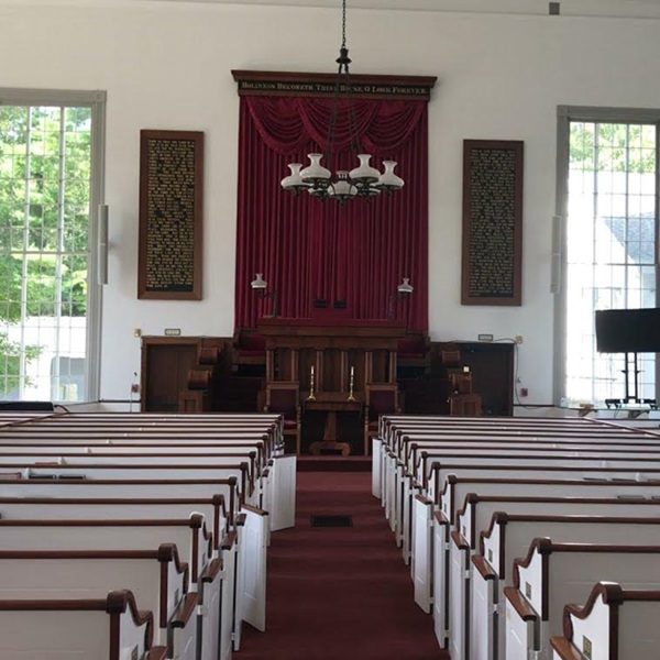 The church building is notable for its traditional New England meetinghouse style, with pews, a pulpit, and large windows that allow natural light to fill the space. 