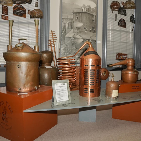 The museum features a vast collection of historic artifacts, including antique bottles, barrels, distilling equipment, and memorabilia related to the bourbon industry. 