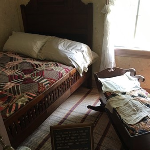 The house is furnished with period-appropriate items, providing a glimpse into late 19th-century life. 