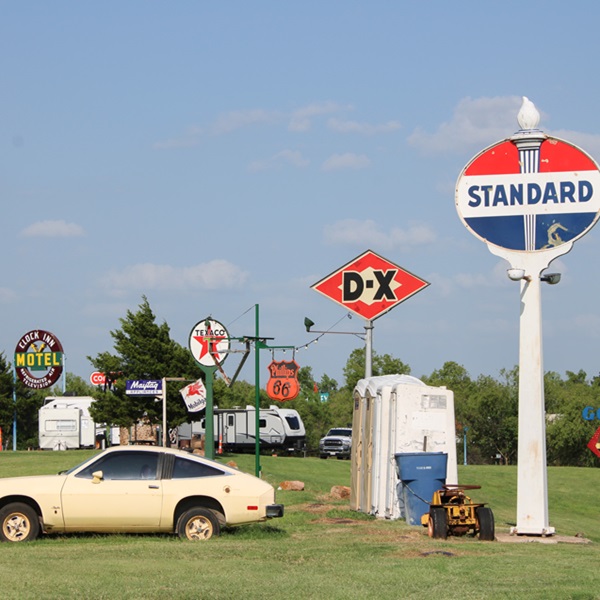 The ranch features a range of automotive memorabilia, including signs, posters, and parts from classic cars. 