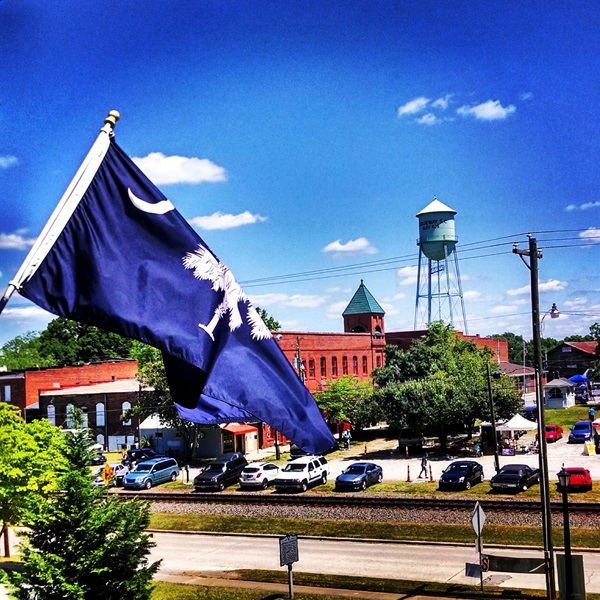 The Cotton Yard Market features vendors selling handmade crafts, fresh produce, and artisanal goods, supporting the community's economy. 
