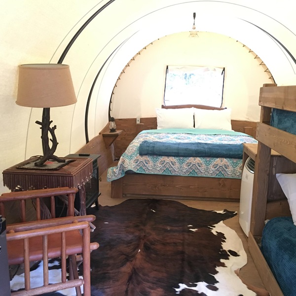 Each wagon is furnished with comfortable beds, heating, and air conditioning, evoking the Old West but equipped with modern amenities. 